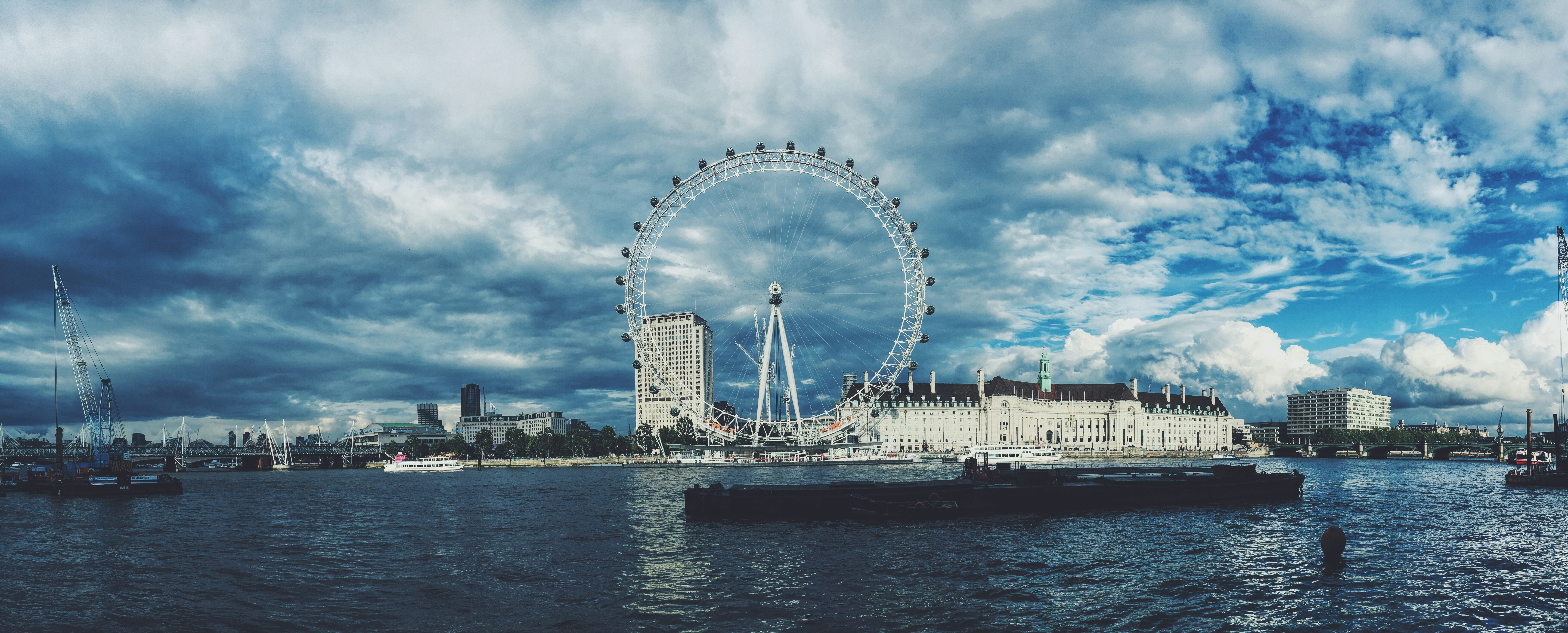 skyline photography of London Eye under white cloudy sky at daytime